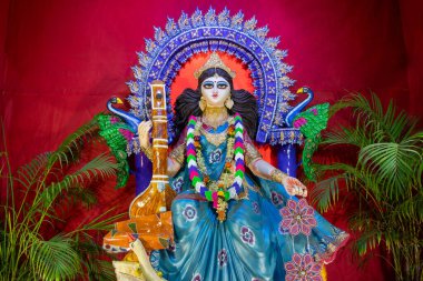 Face of Goddess Saraswati at Kolkata, West Bengal, India. Saraswati is Hindu goddess of knowledge, music, art, wisdom, and learning. Worshipping is done to get divine blessing to achieve excellence. clipart