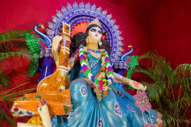 Idol of Goddess Saraswati at Kolkata, West Bengal, India. Saraswati is Hindu goddess of knowledge, music, art, wisdom, and learning. Worshipping is done to get divine blessing to achieve excellence. clipart