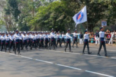 Hindistan 'ın Ulusal Hizmet Planı (NSS) öğrencilerinin bulanık görüntüsü, Hindistan Cumhuriyet Günü kutlamaları için bayrağın önünden geçiyor. Kolkata, Batı Bengal, Hindistan.