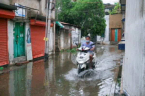 Blurred image of Howrah, West Bengal, India. Rain water logged road, due to Super cyclone Amphan. The devastation has made many damages to West Bengal state.