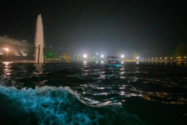 Blurred image of Brindavan or Vrindaban Gardens is a garden adjoining the Krishnarajasagara Dam , across the river Kaveri. Waterbody at night inside garden, Mysore, Karnataka, India.