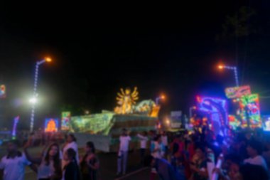 Kırmızı yoldaki Durga Puja Karnavalı 'nın bulanık görüntüsü, Durga Puja festivalinin son günlerinde tüm ünlü Durga putları birer birer yol kenarında toplanıyor..