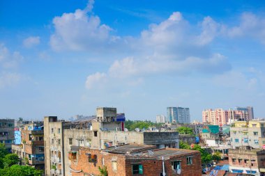 Modern ve eski binaların mimarisi, mavi gökyüzü ve arka planda beyaz bulutlar. Kolkata, Batı Bengal, Hindistan.