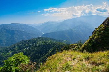 View of Himalayan mountain, blue sky and forest from Tarey Bhir point, tourist spot, Sikkim, India. 'Bhir' means cliff in the local language,about 10,000 feet long path, breathtaking view at the edge.
