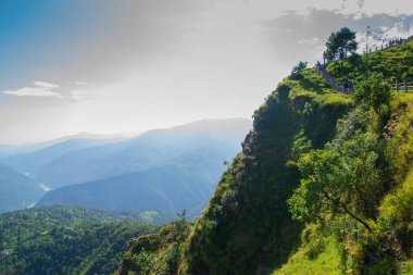 View of Himalayan mountain, blue sky and forest from Tarey Bhir point, tourist spot, Sikkim, India. 'Bhir' means cliff in the local language,about 10,000 feet long path, breathtaking view at the edge.
