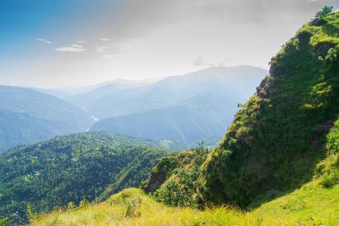 View of Himalayan mountain, blue sky and forest from Tarey Bhir point, tourist spot, Sikkim, India. 'Bhir' means cliff in the local language,about 10,000 feet long path, breathtaking view at the edge.