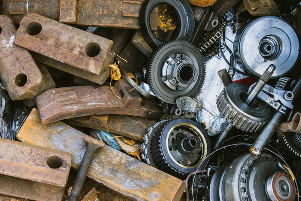 Engine and gearbox gears, car recycling, scrap metal collection point, ecology concept.