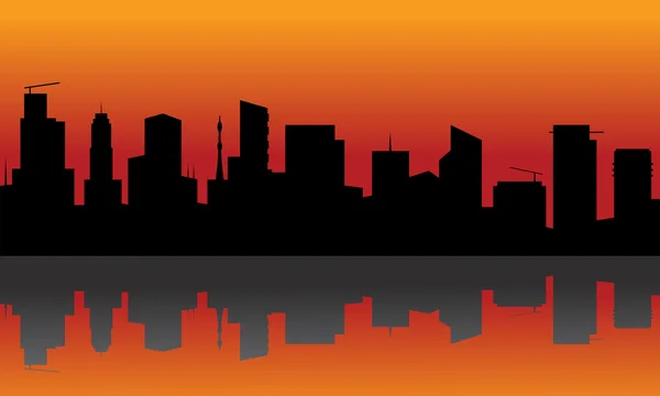 Silhouette de ville avec fond orange — Image vectorielle