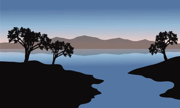 Silhouet van lake en bomen — Stockvector