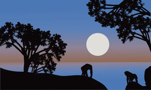 Ilustrace gorila silueta s měsícem — Stockový vektor