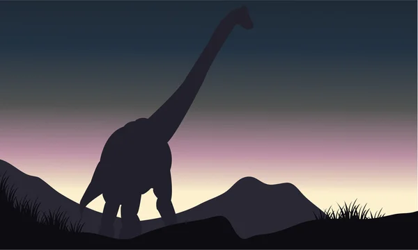 Silhouette di singolo brachiosauro in collina — Vettoriale Stock