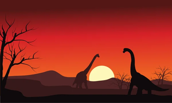 Silhouette de deux brachiosaures au coucher du soleil — Image vectorielle