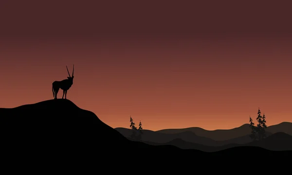 Sur les collines silhouette paysage antilope — Image vectorielle