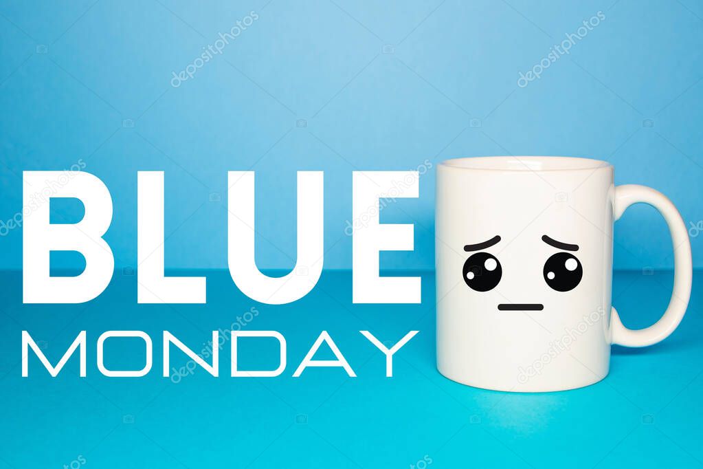 Close-up of a white mug on a blue background looking sad. Concept of sadness caused by Covid-19, new normal and Blue Monday.