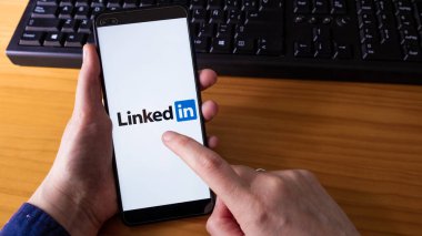 İspanya, 04, 08, 2021. Ekranda LinkedIn uygulaması olan bir kadın akıllı telefon tutuyor.
