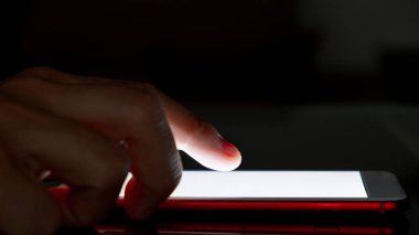 Akşamları akıllı telefonunu kullanan bir adamın yakın çekimi. Uykusuzluk konsepti. Gece mobil aygıtların kullanımı