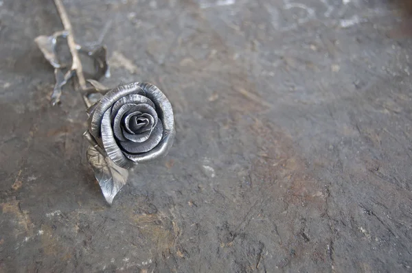 Metal rose on shabby wood background — Stok Foto