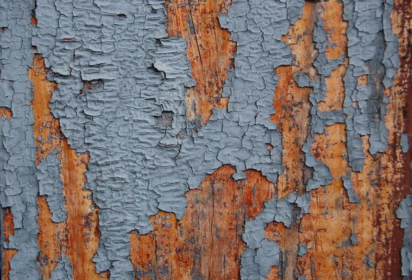 Vecchio modello di vernice incrinata su sfondo di legno. Pittura peeling . — Foto Stock