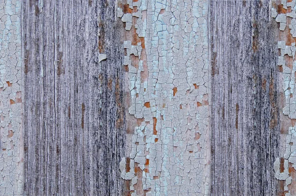 Tinta rachada em uma parede de madeira . — Fotografia de Stock