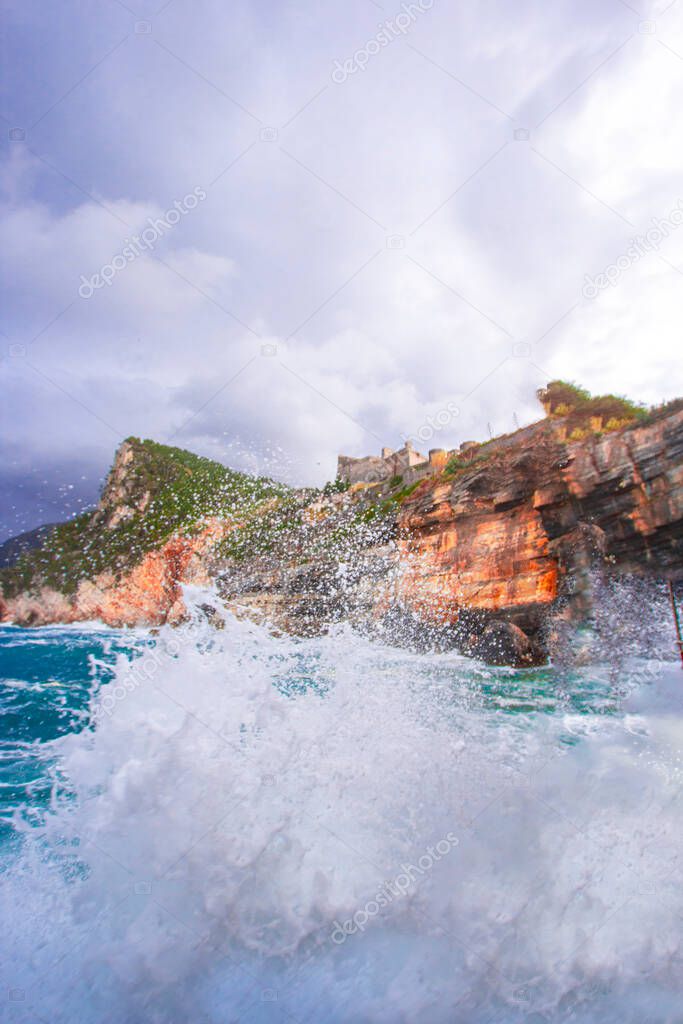 Portovenere (porto venere) Doria castle in Liguria Italy near cinque terre. Waves breaking on rocky coastline
