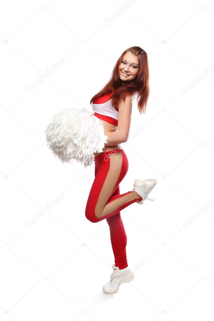 Young sports flexible cheerleader girl in red sweatpants and red top holding pom-poms.