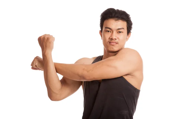Muskulös asiatisch mann stretching seine arm — Stockfoto