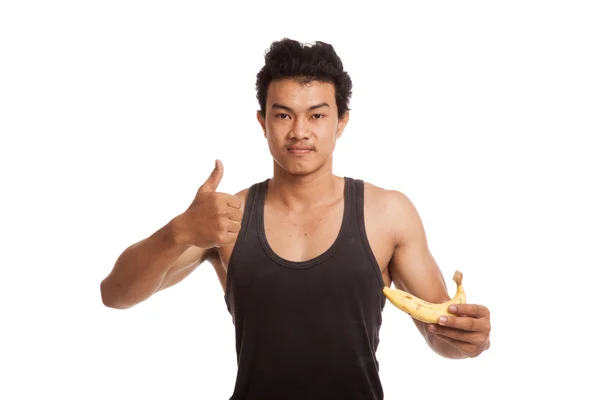 Muskularny mężczyzna Azji kciuki z bananem — Zdjęcie stockowe