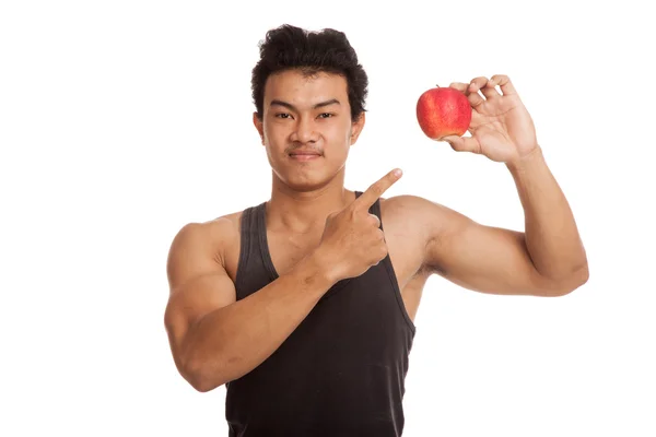 Muskulöser asiatischer Mann zeigt auf roten Apfel — Stockfoto