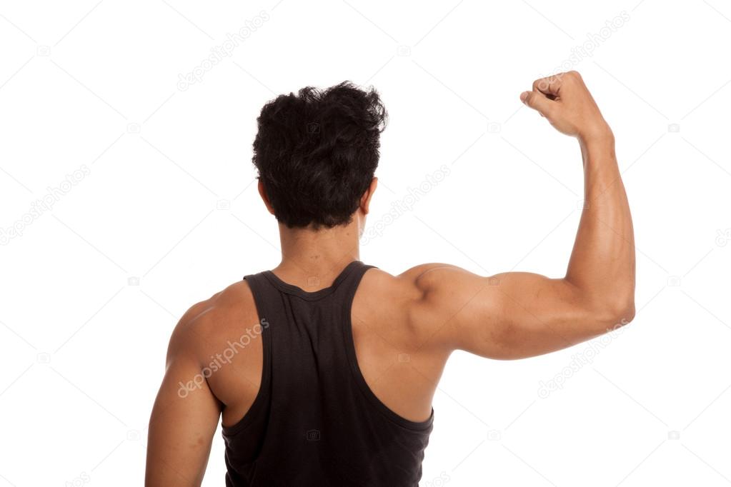 Muscular Asian man's arm flexing biceps with measuring tape Stock Photo