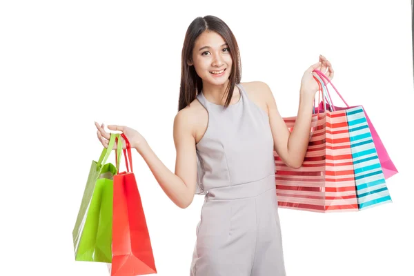 Beautiful young Asian woman with shopping bags — Stock Photo, Image