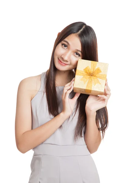 Beautiful young Asian woman with golden gift box — Stock Photo, Image