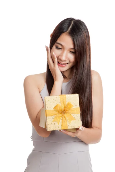 Excited beautiful young Asian woman with golden gift box — Stock Photo, Image