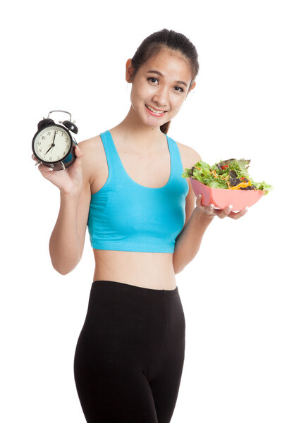 Beautiful Asian healthy girl with clock and salad