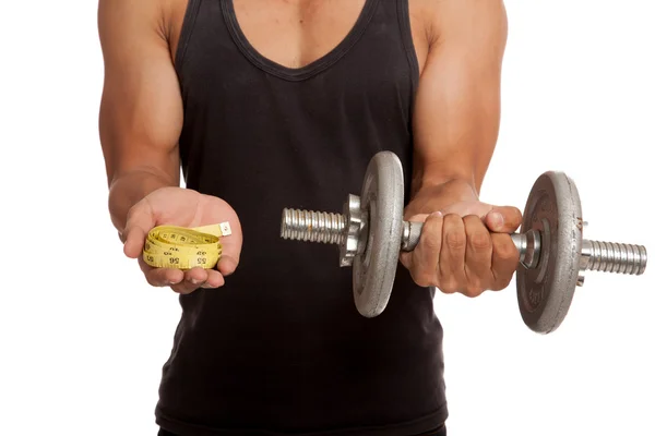 Muscular Asian man with measuring tape and dumbbell — Stock Photo, Image