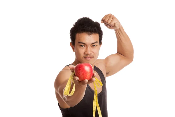 Muscular Asian man flexing biceps with measuring tape and apple — Stock Photo, Image