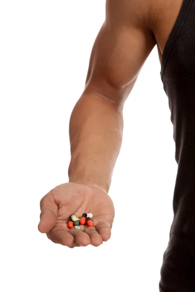 Muscular Asian man with drug pills — Stock Photo, Image