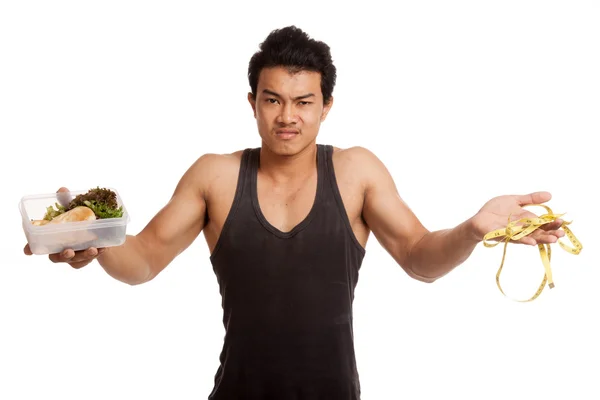 Muscular asiático hombre dieta con cinta métrica y limpiar alimentos — Foto de Stock