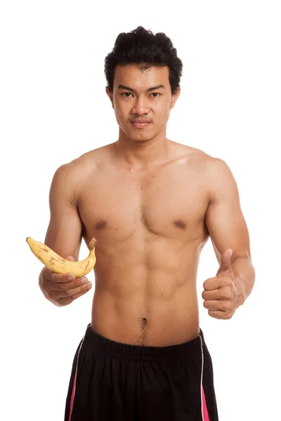 Muscular Asian man with banana — Stock Photo, Image