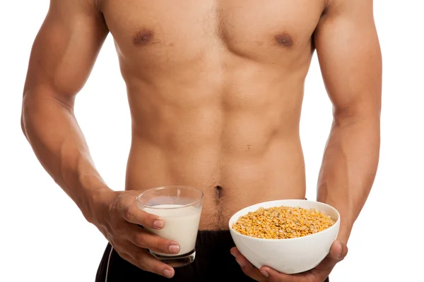 Muscular Asian man with soybeans and soy milk — Stock Photo, Image