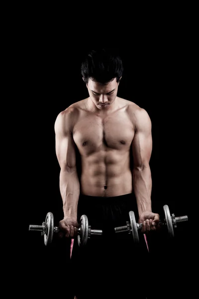 Muscular Asian man with dumbbell — Stock Photo, Image