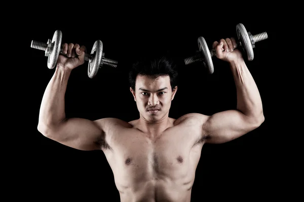 Muscular Asian man with dumbbell — Stock Photo, Image