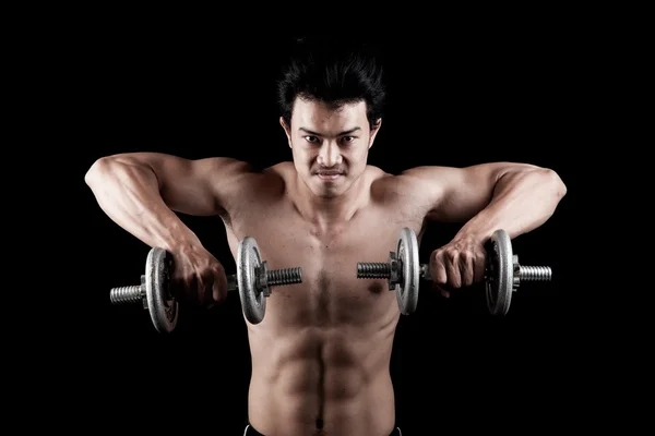 Muscular Asian man with dumbbell — Stock Photo, Image