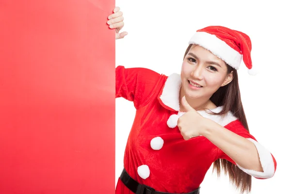 Asian Christmas girl with Santa Claus clothes thumbs up with bla — Stock Photo, Image