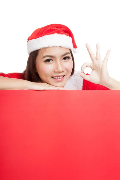 Asian Christmas girl with Santa Claus clothes show OK with blank — Stock Photo, Image