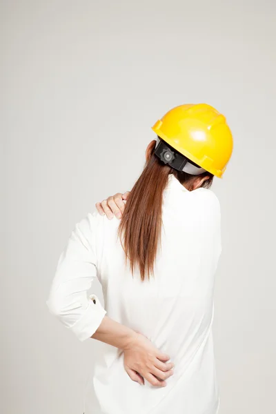 Back of Asian Engineer girl with hard hat got back pain — Stock Photo, Image