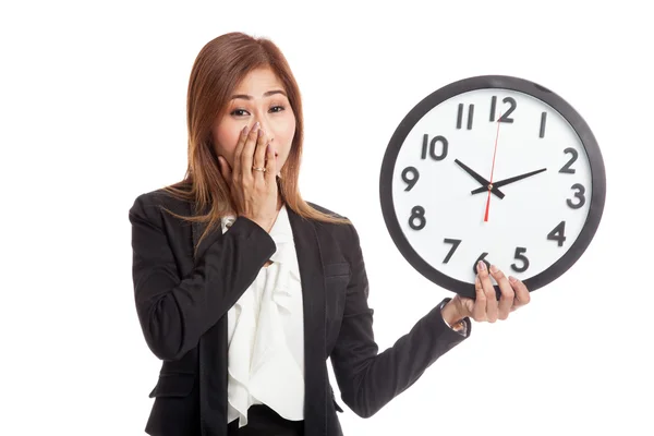 Sleepy young Asian business woman with a clock in the morning — Stock Photo, Image
