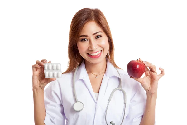 Young Asian female doctor with pills and apple — Stock Photo, Image
