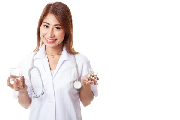 Young Asian female doctor with water and medicine — Stock Photo, Image