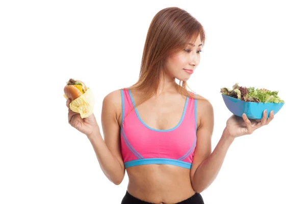 Beautiful Asian healthy girl with salad and hamburger — Stock Photo, Image