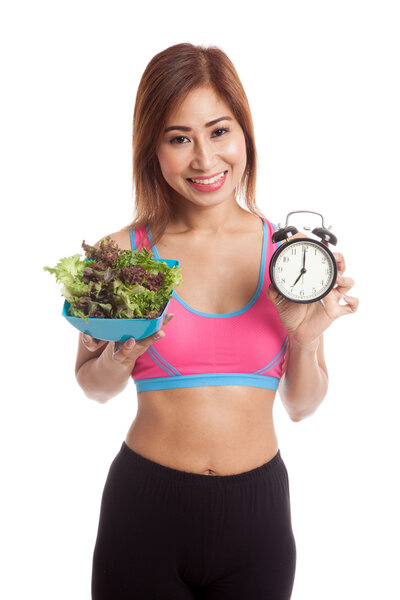 Beautiful Asian healthy girl with clock and salad